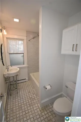 a bathroom with a toilet a sink and a shower