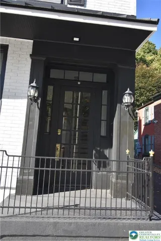 a view of entryway with a wooden fence