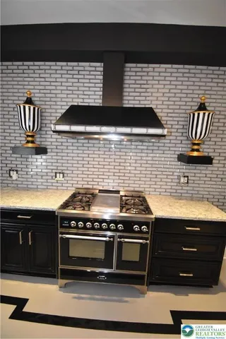 a stove top oven sitting inside of a kitchen