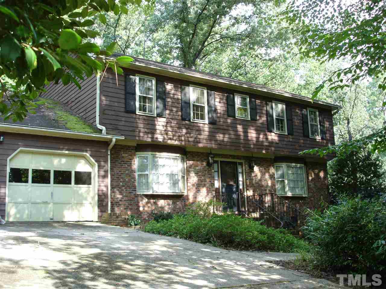 4516 Oak Park Road Raleigh, NC 27612 - Photo 1 of 17 a front view of a house with a garden