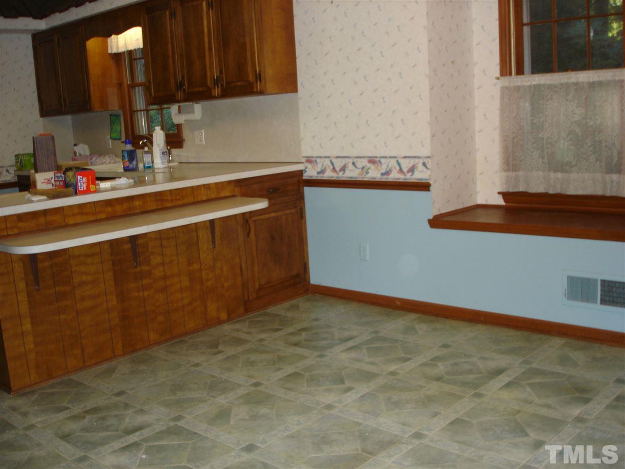 4516 Oak Park Road Raleigh, NC 27612 - Photo 6 of 17 a kitchen with granite countertop a sink and cabinets
