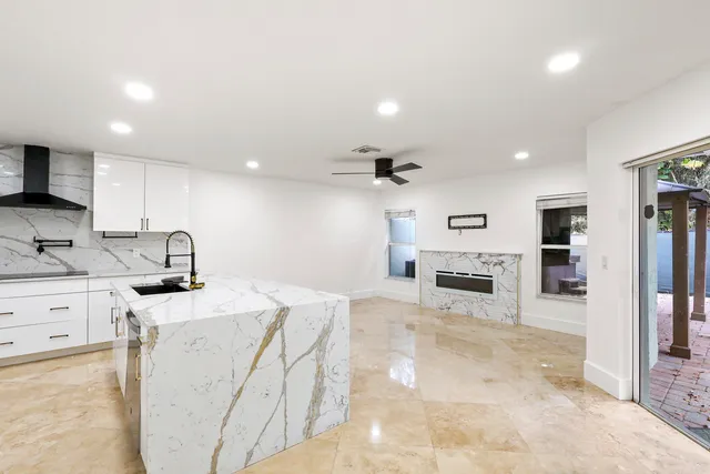a kitchen with granite countertop a sink appliances and cabinets