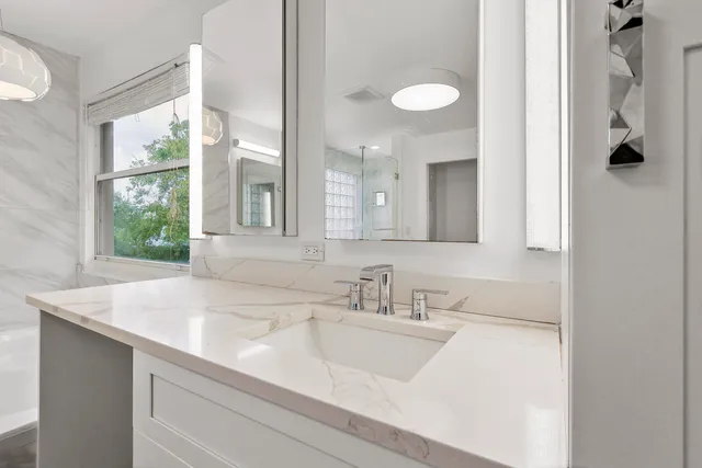 a bathroom with a sink and a mirror