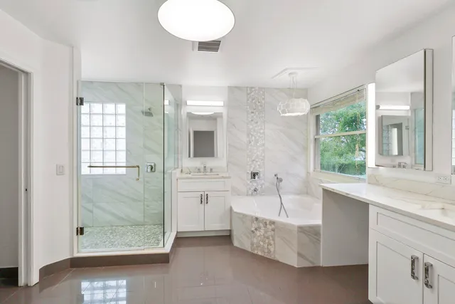 a bathroom with a double vanity sink mirror and shower