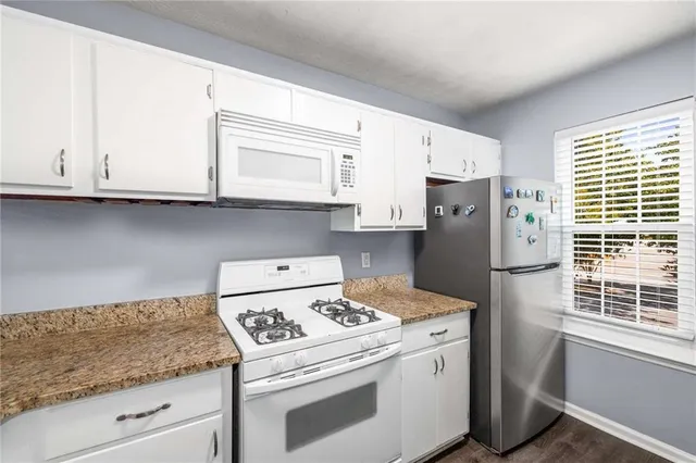 a kitchen with a white cabinets and white appliances