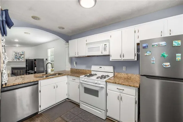 a kitchen with a white cabinets and white appliances