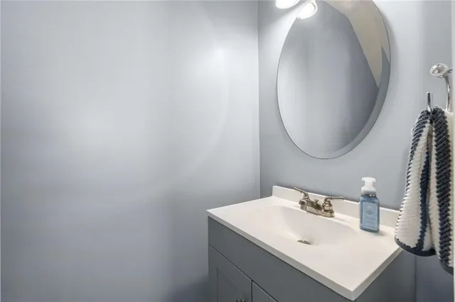 a bathroom with a sink vanity and a mirror