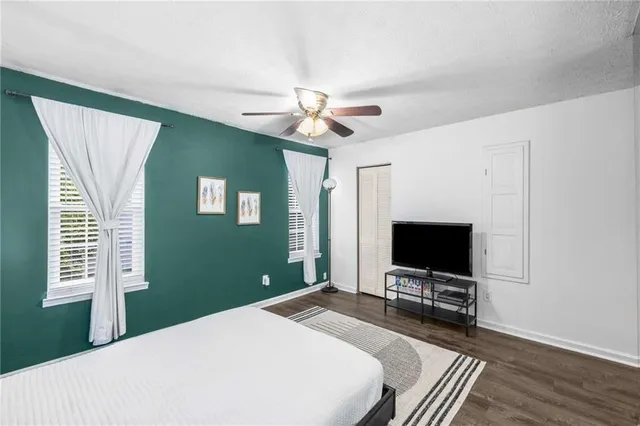 a bedroom with a bed and a flat screen tv