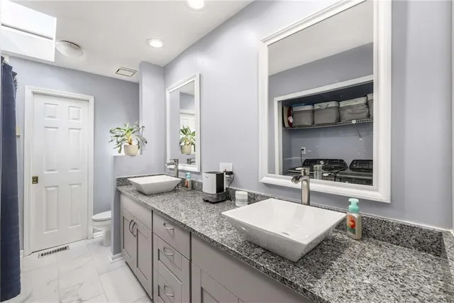 a kitchen with granite countertop a sink and a stove top oven