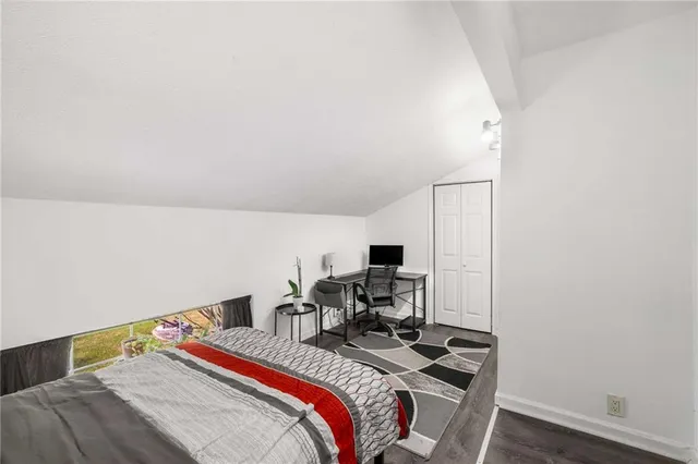 a bedroom with a bed and a desk