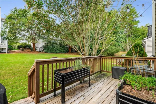 a view of balcony with wooden floor and fence