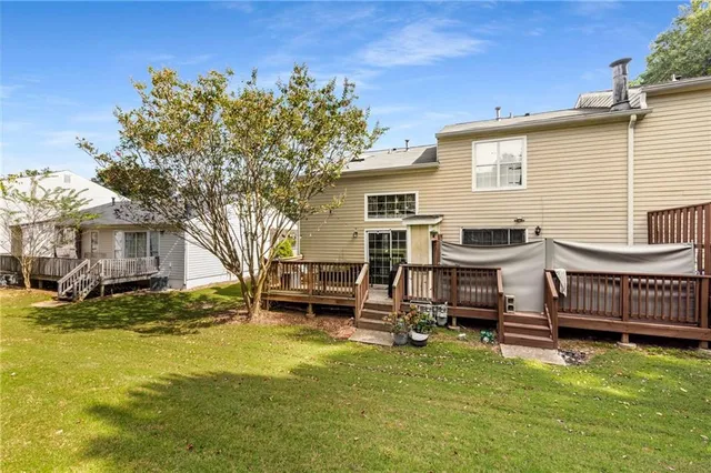 a view of a house with backyard porch and sitting area