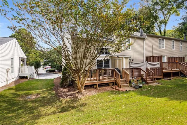 a view of a house with backyard porch and sitting area
