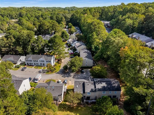 an aerial view of a house with a yard