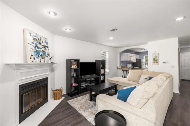a living room with furniture a fireplace and a flat screen tv