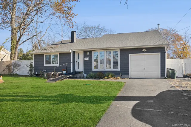 a front view of a house with a garden and yard