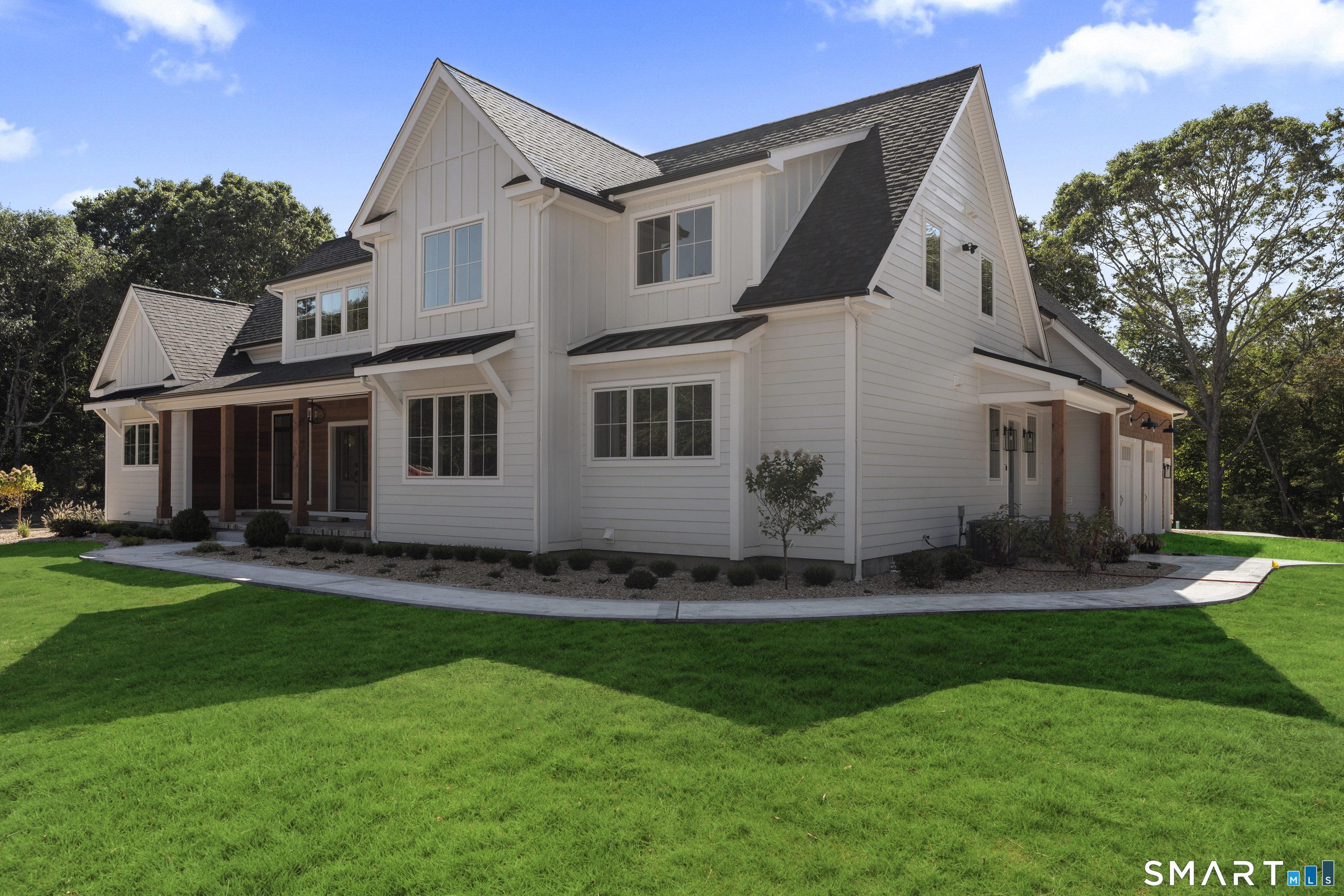 a front view of a house with a yard and many windows
