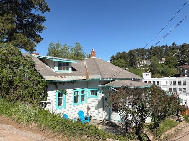 a view of a house with a yard and sitting area
