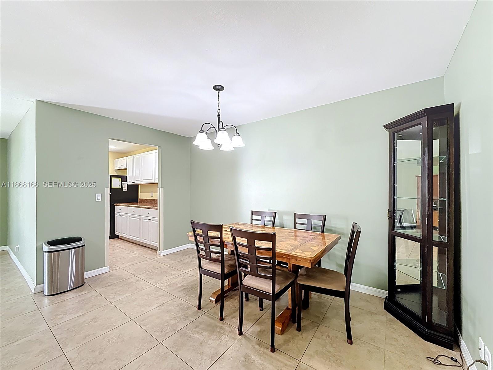 290 Main Boulevard, Unit C Boynton Beach, FL 33435 - Photo 13 of 56 a view of a dining room with furniture and a chandelier