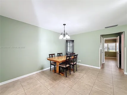 a dining room with furniture and chandelier
