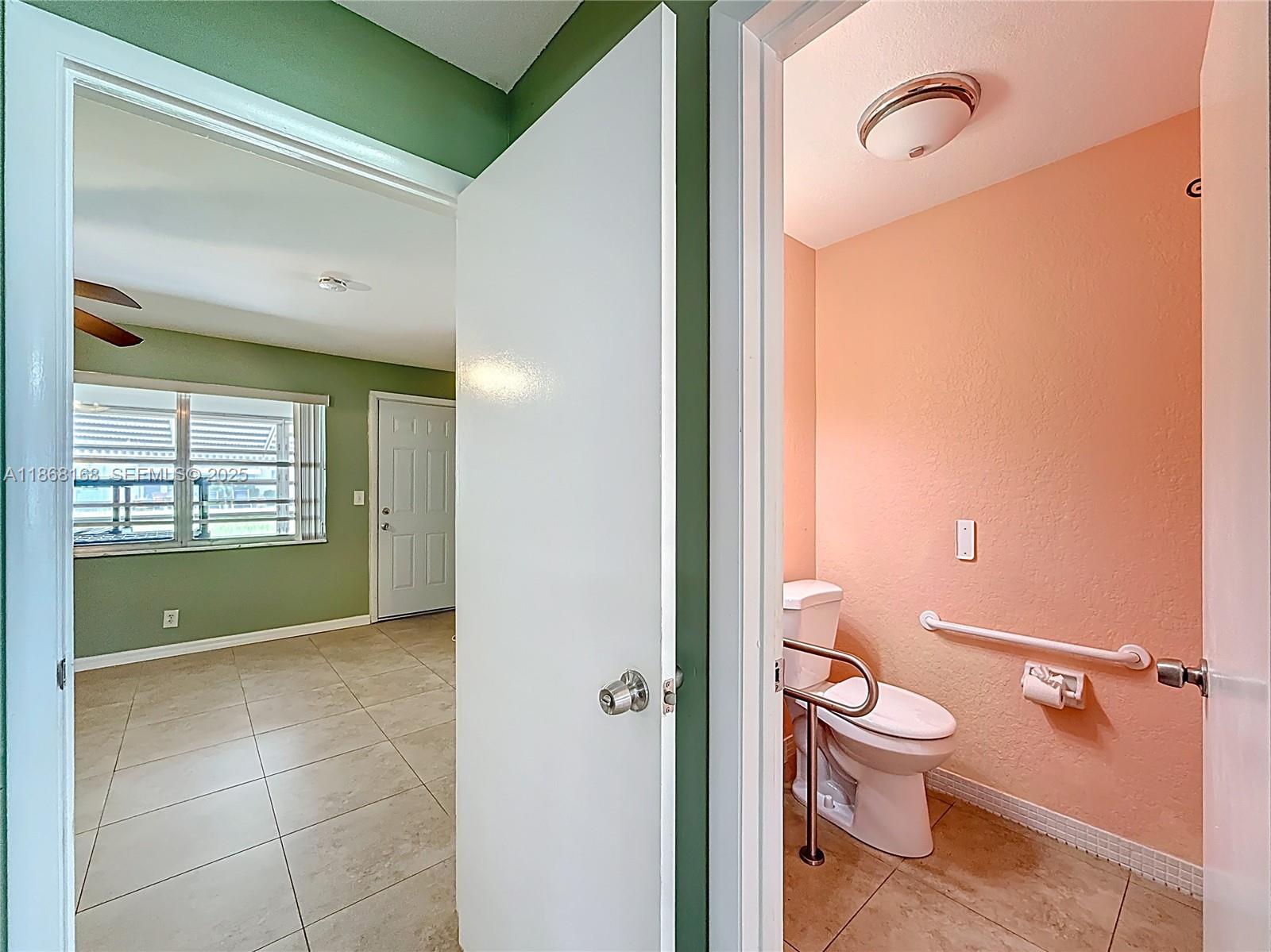 290 Main Boulevard, Unit C Boynton Beach, FL 33435 - Photo 24 of 56 a bathroom with a toilet sink and mirror