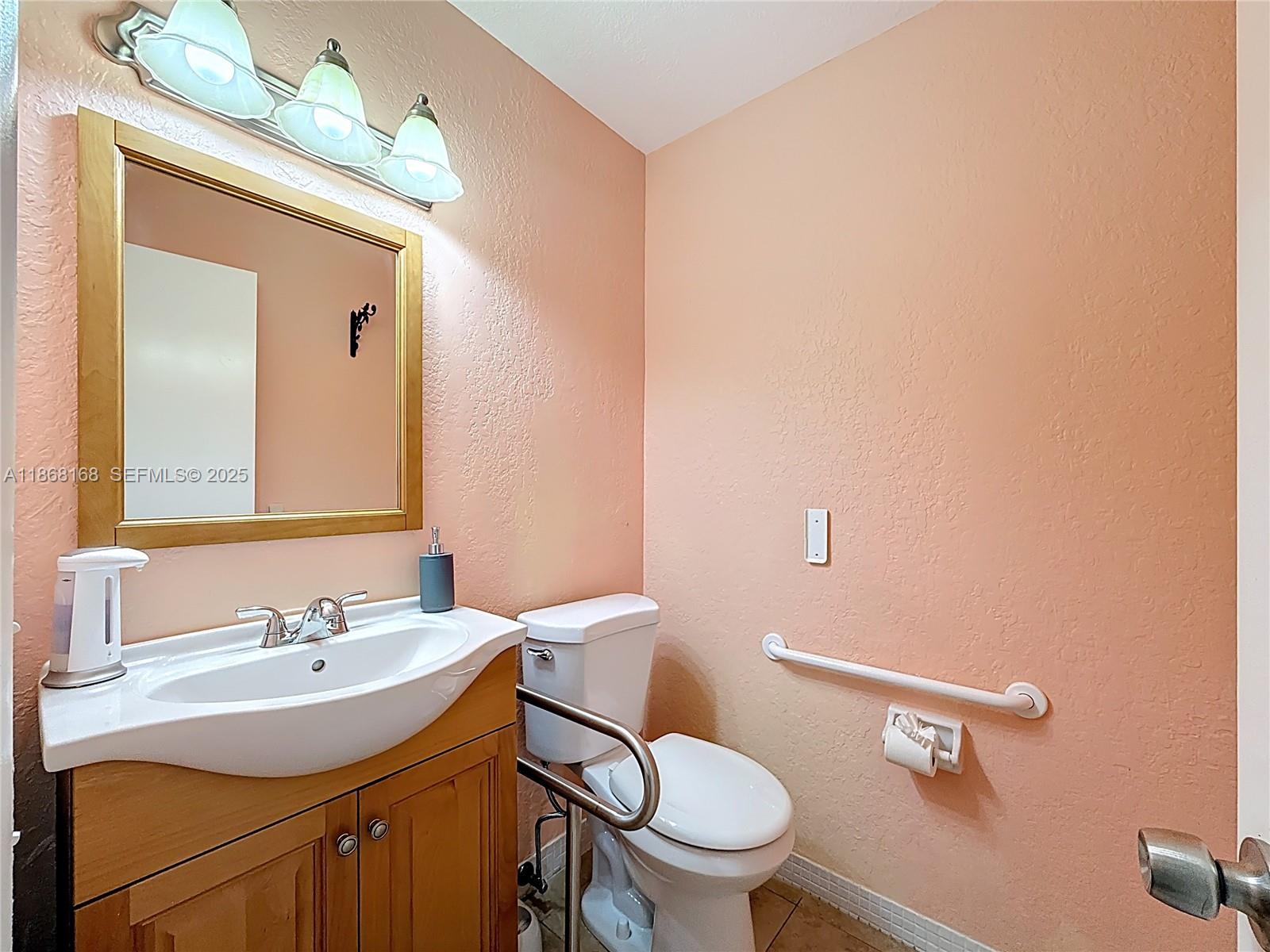 290 Main Boulevard, Unit C Boynton Beach, FL 33435 - Photo 25 of 56 a bathroom with a sink a toilet and mirror