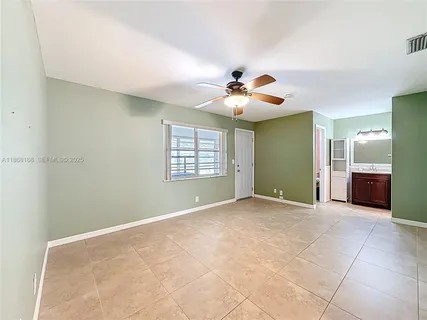 a view of an empty room with a ceiling fan