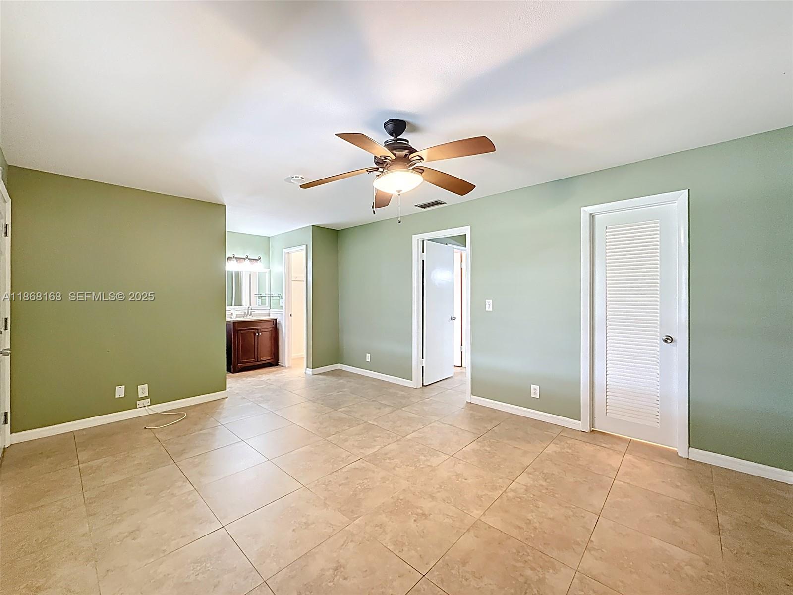 290 Main Boulevard, Unit C Boynton Beach, FL 33435 - Photo 30 of 56 a view of an empty room with a ceiling fan