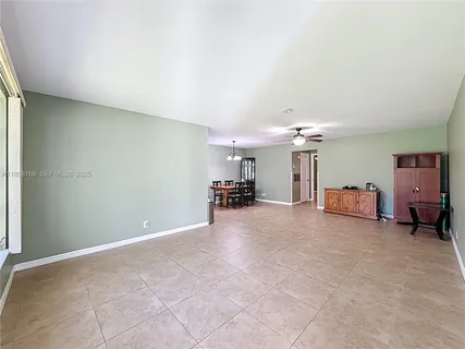 a view of a livingroom with furniture and a ceiling fan