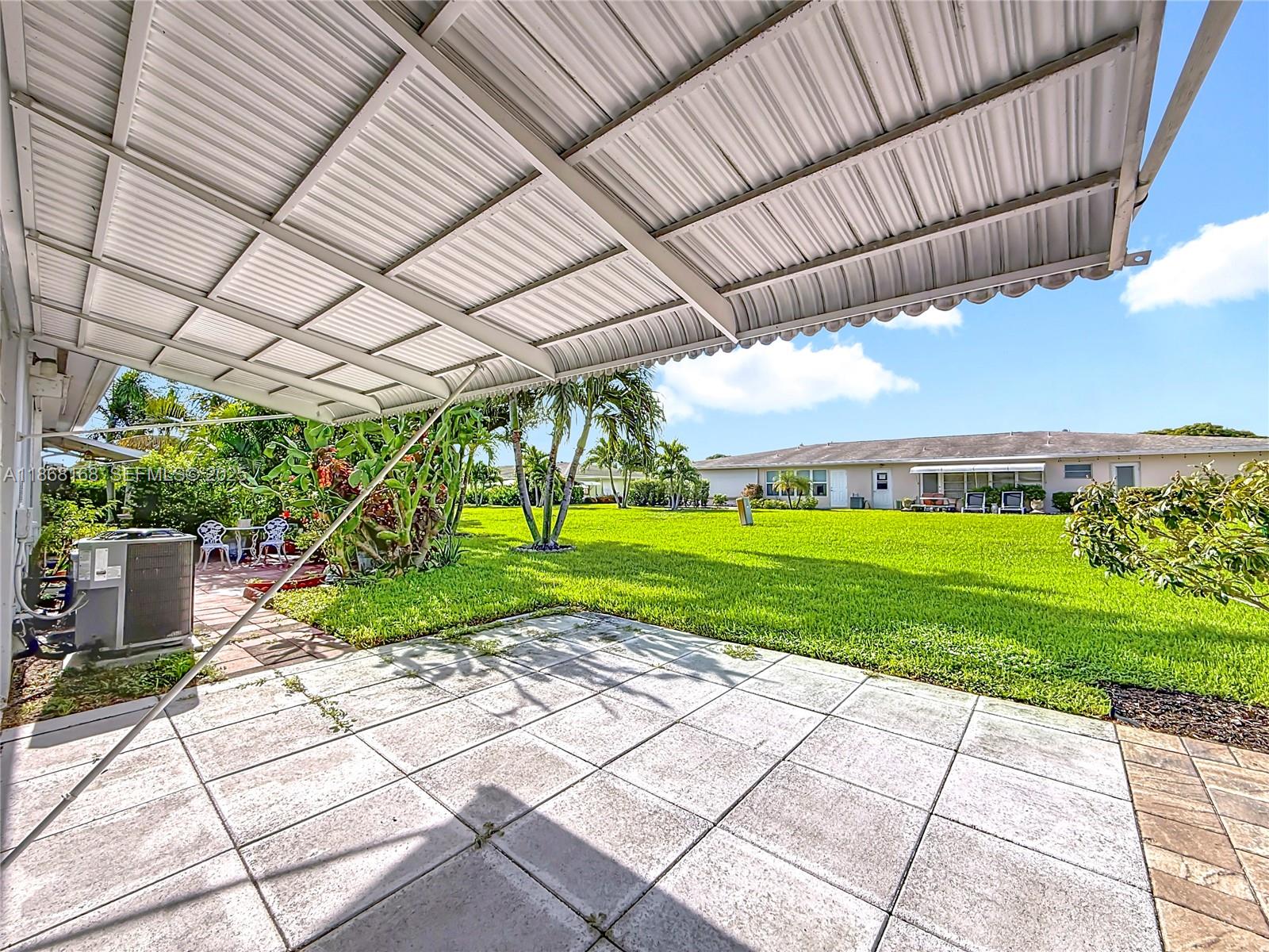 290 Main Boulevard, Unit C Boynton Beach, FL 33435 - Photo 41 of 56 a view of a yard with plants and a garden