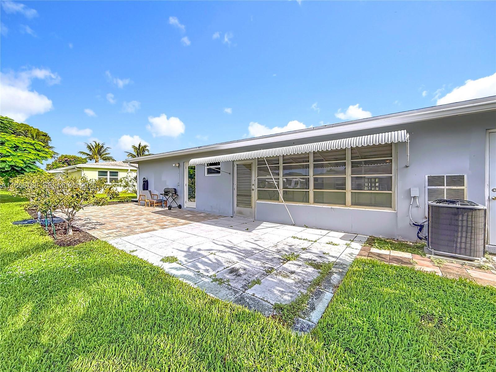 290 Main Boulevard, Unit C Boynton Beach, FL 33435 - Photo 44 of 56 a front view of a house with a yard