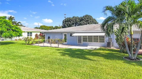 an aerial view of a house with a yard and potted plants