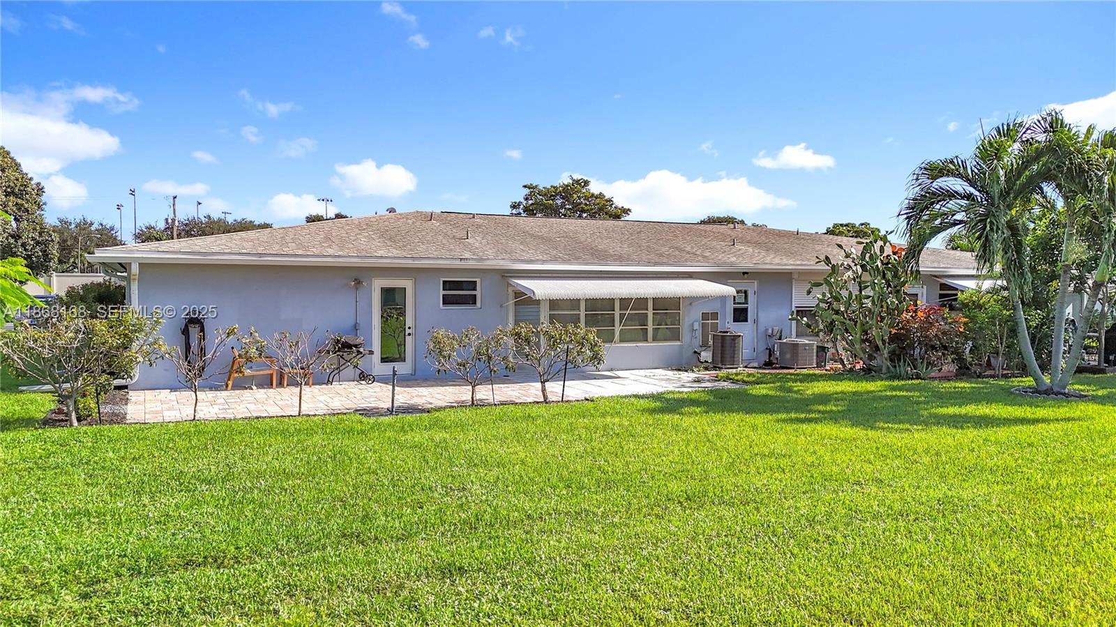 290 Main Boulevard, Unit C Boynton Beach, FL 33435 - Photo 48 of 56 a front view of a house with a garden