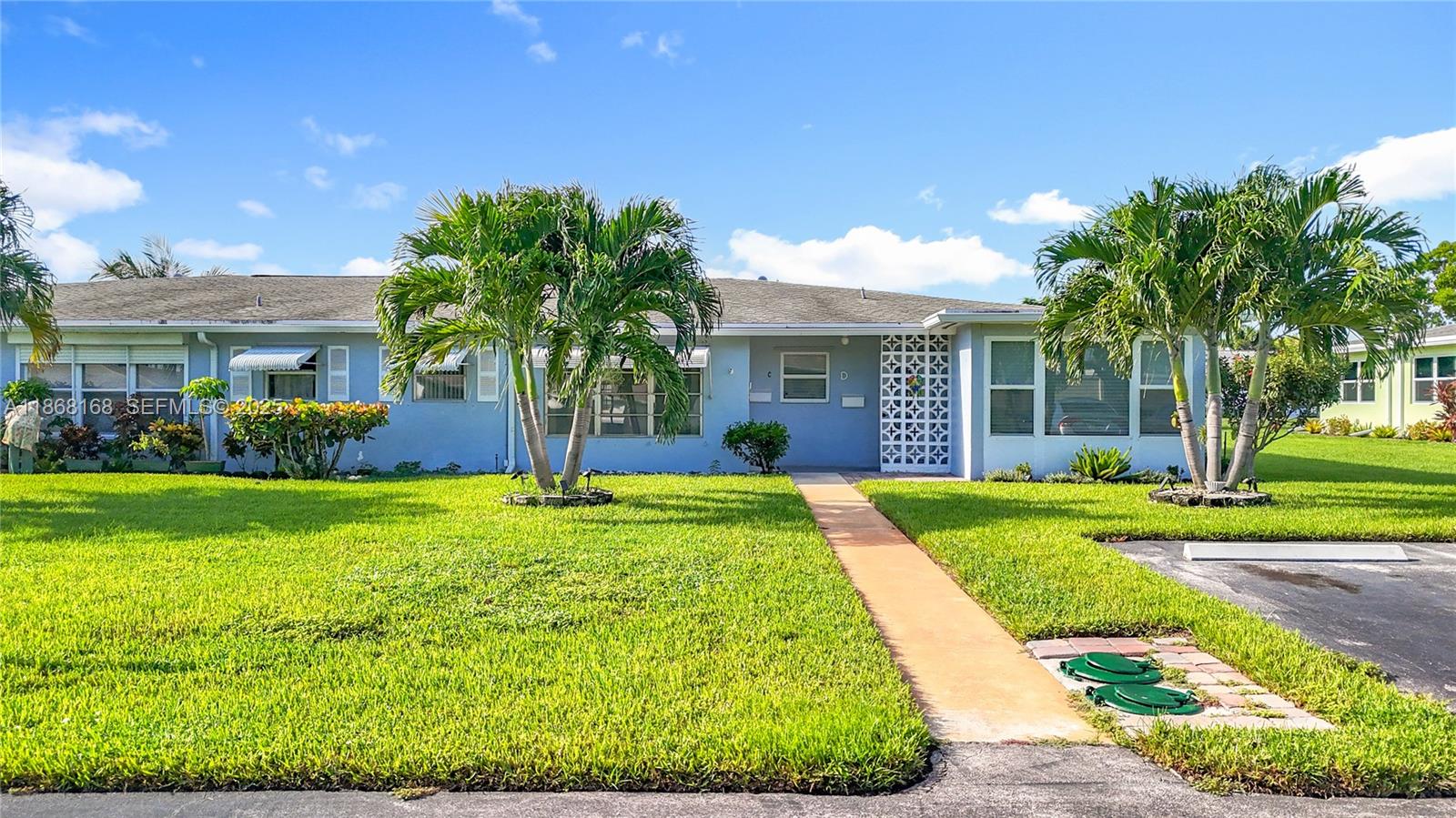 290 Main Boulevard, Unit C Boynton Beach, FL 33435 - Photo 49 of 56 a front view of a house with garden