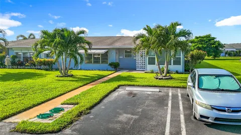 an aerial view of a house with a swimming pool outdoor seating and yard