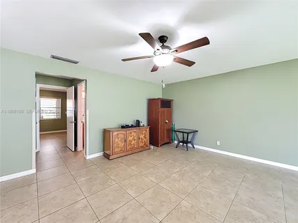 a dining room with furniture and a ceiling fan