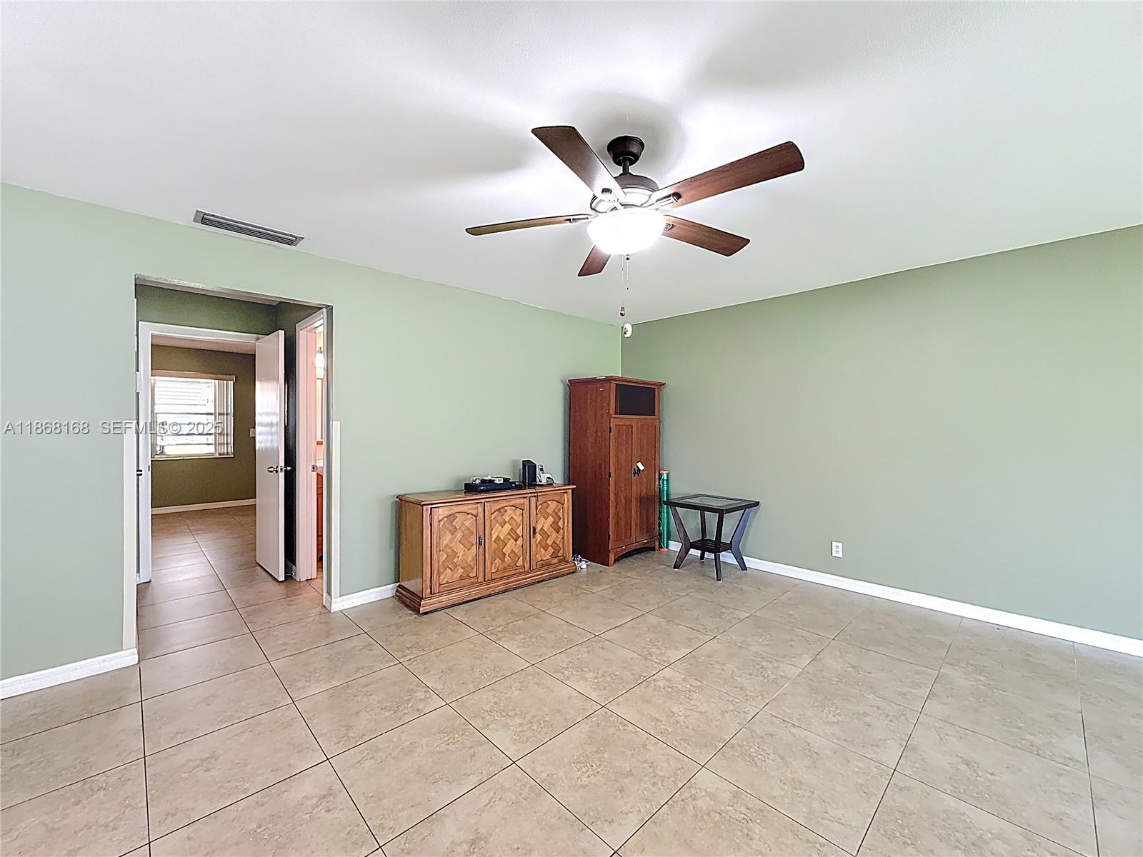 290 Main Boulevard, Unit C Boynton Beach, FL 33435 - Photo 10 of 56 a dining room with furniture and a ceiling fan
