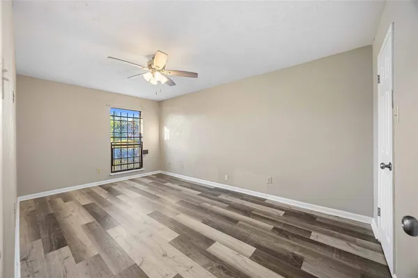 a view of room with a ceiling fan and window