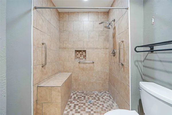 a bathroom with a shower and a toilet