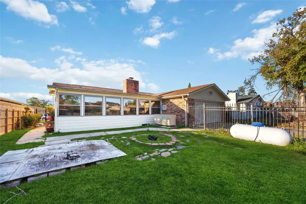 a front view of a house with a yard table and chairs
