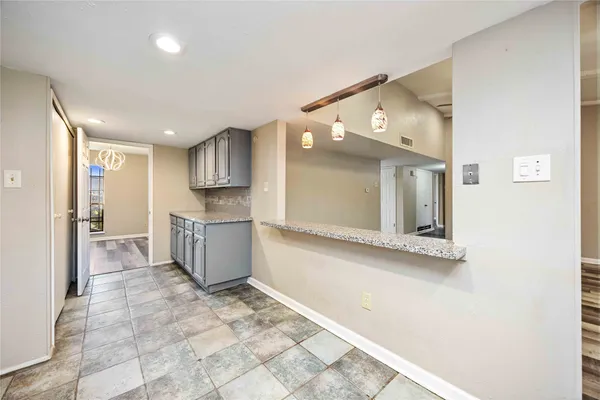 a view of a kitchen with a sink and cabinets