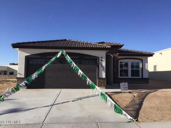 a front view of a house with garage