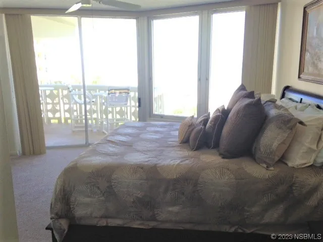 a large bed sitting in a bedroom next to a window