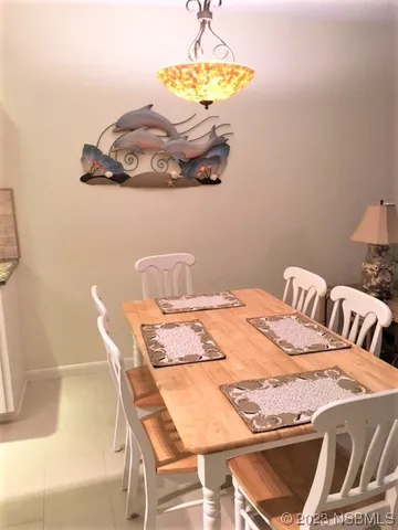 a dining room with a table chairs and chandelier