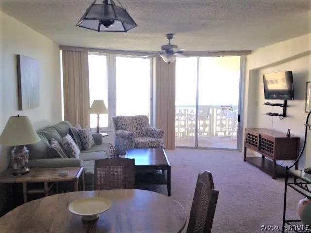 a living room with furniture and a floor to ceiling window