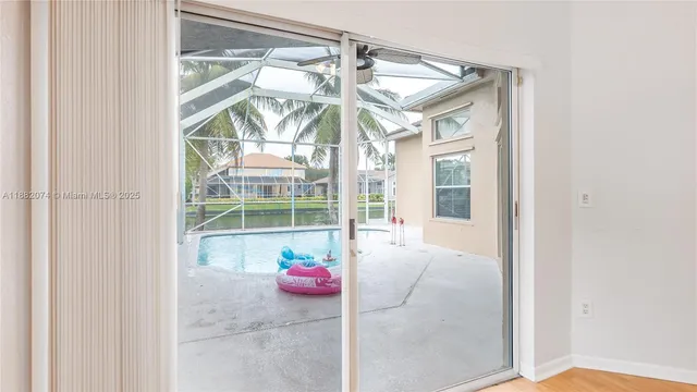 a view of a room that has a window and a bed