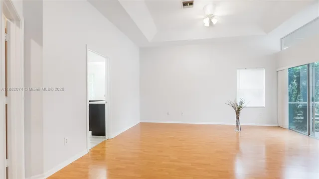 a view of empty room with wooden floor