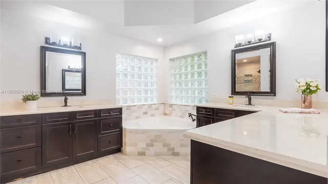 a spacious bathroom with a bathtub sink and mirror