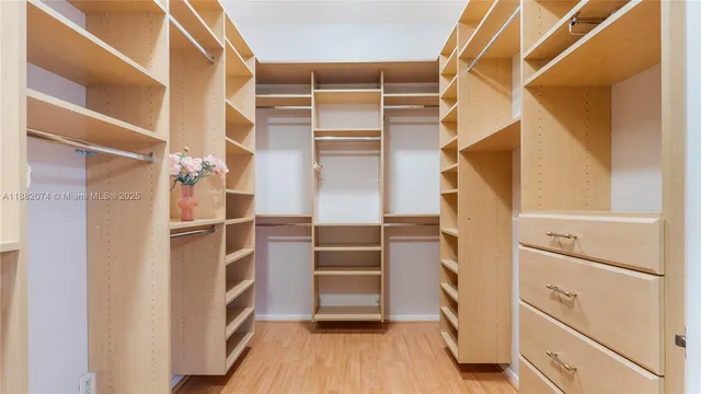 a view of walk in closet with empty racks