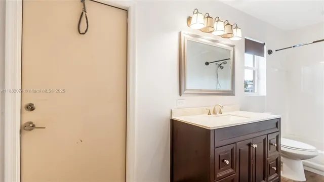 a bathroom with a sink vanity and a mirror